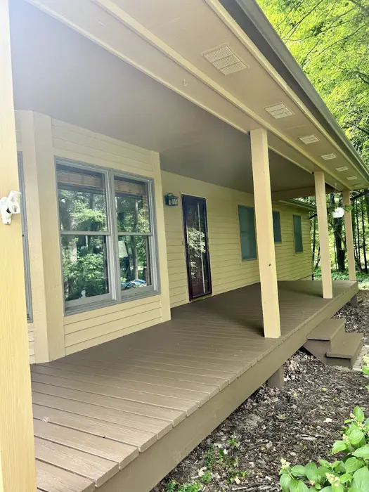 Covered front porch with painted siding and trim