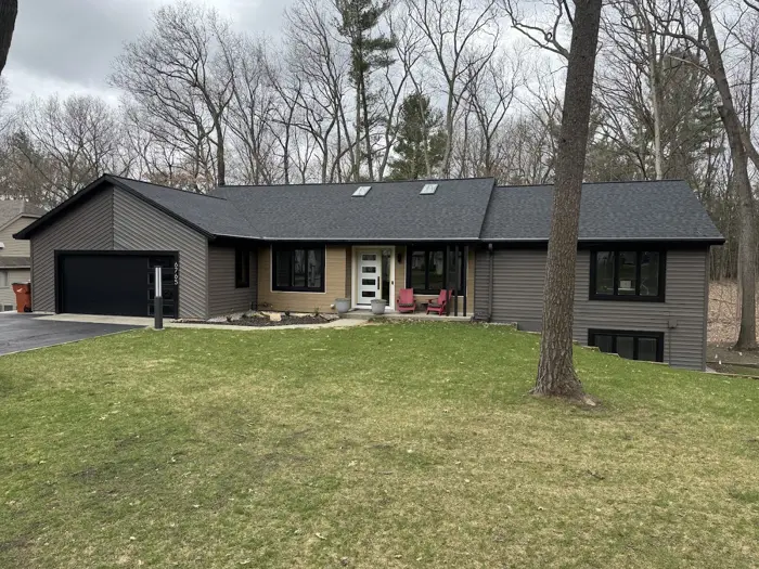 Ranch home exterior repainted in charcoal